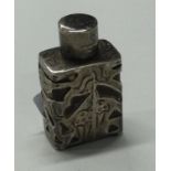 A pierced silver scent bottle with screw-top lid.