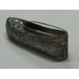 An early 20th Century Chinese export silver shoe with clear glass liner.
