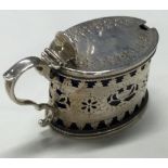 A Victorian silver mustard pot with pierced decoration.