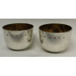 A pair of Britannia Standard silver tumbler cups with gilt interiors.