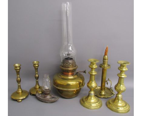 Collection of brass candlesticks, oil lamp and a small metal oil lamp in the shape of a slipper