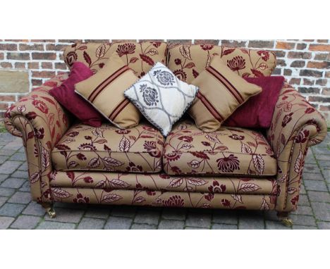 Modern sofa with floral pattern design on castors with scatter cushions L 180cm D 100cm Ht 90cm