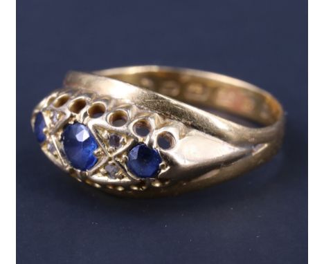 A Victorian sapphire and diamond dress ring, having a 4 mm sapphire flanked by 3 mm sapphires, each separated by two diamond 