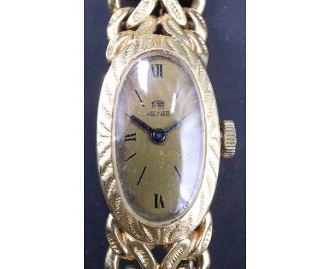 An 18 ct gold wristlet watch by Milner, having a 17 jewel Bueche-Girod movement, the dial marked Milner, in an oblate case on