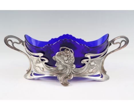 An Jugendstil WMF electroplated britannia metal and glass flower bowl, the two handled stand cast with a maiden's head among 