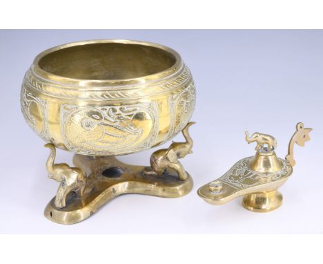 A SriLankan brass oil lamp, having an elephant form stopper and engraved decoration, together with a brass cachepot on a base
