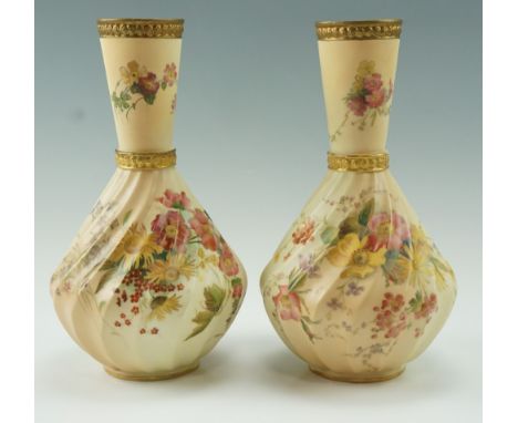 A pair of Edwarian Royal Worcester floral decorated blush ivory vases, of baluster form with an inverted conical neck and spi