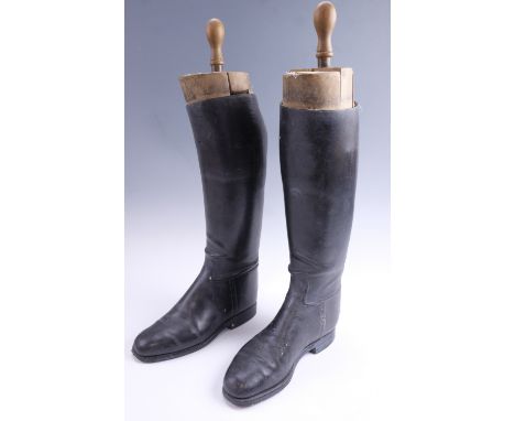 A pair of vintage leather riding boots and wooden trees