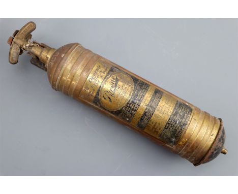 A vintage automotive pyrene fire extinguisher and mounting bracket