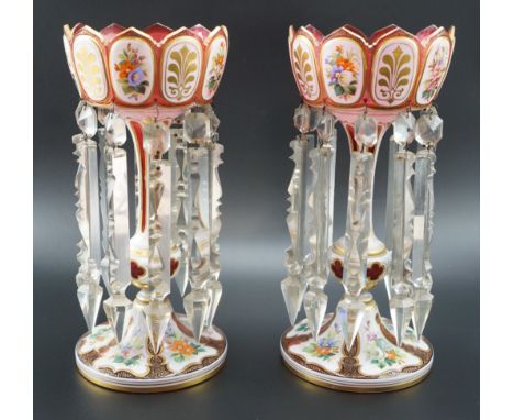 A pair of Bohemian style glass lustres, each decorated with alternating floral enamelled and gilt honeysuckle plaques on a gi