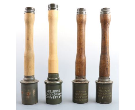 Three replica German Third Reich stick grenades and a wooden prop example