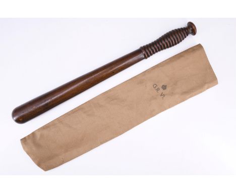 A vintage Police turned mahogany truncheon, in khaki cotton slip bearing George VI government property stamp, 44 cm. (Trunche