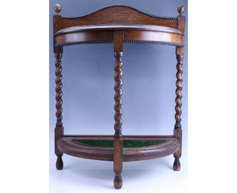 A George V oak demi-lune umbrella / stick stand, having bine twist supports, 58 x 25.5 x 75 cm