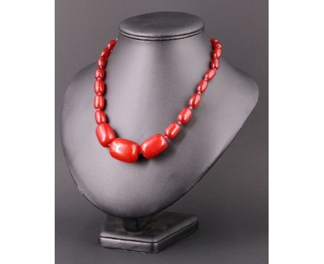 A vintage graduated cherry amber type Bakelite matinee length necklace, having a later white metal barrel clasp, beads 28 x 2