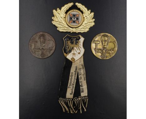 A Great War Prussian army veteran's pin badge, a veterans' association cap-type badge and two German Third Reich day badges, 