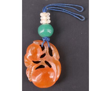 A Chinese carved peach jade pendant in the form of fruit, 3 cm x 2 cm