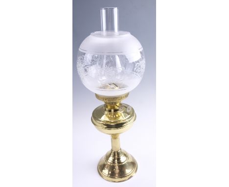 A late 20th Century brass twin wick oil lamp, having a frosted and floral decorated glass globe, 55 cm