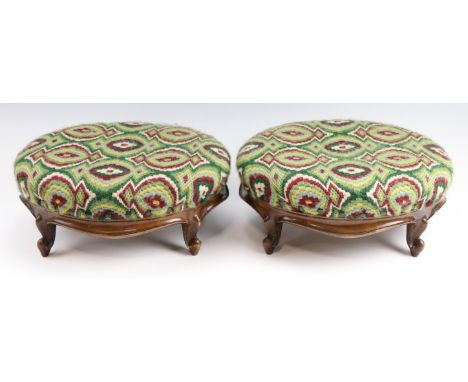 A pair of Victorian carved walnut foot stools, having tapestry upholstery, 34 x 30 x 16 cm