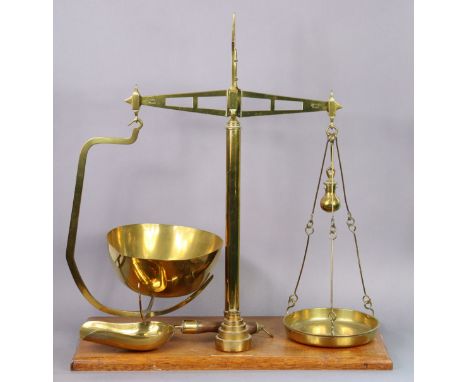 A set of vintage brass counter-top beam scales by Bartlett &amp; Sons of Bristol (to weigh 2lbs) with a set of seven brass we