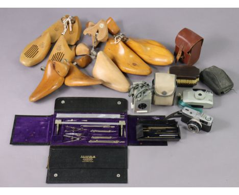 Four pairs of vintage treen shoe trees; together with four cameras; &amp; two sets of drawing implements. 