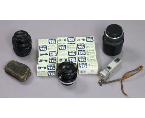 Three various camera lenses; a Minolta “16” spy camera, cased; &amp; fourteen ditto films, boxed. 