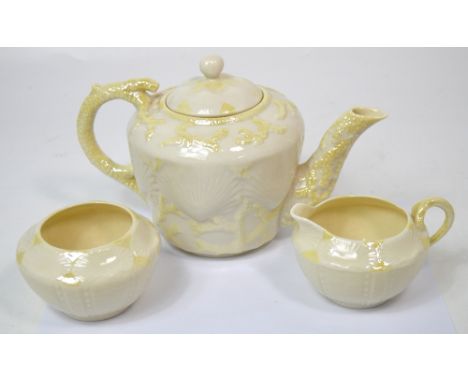 A three piece Belleek tea service comprising teapot, height 17cm, basin and milk jug (3).