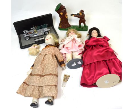 A collectors' lot to include a reproduction cast iron automaton money box, three Franklin Mint porcelain dolls with certifica