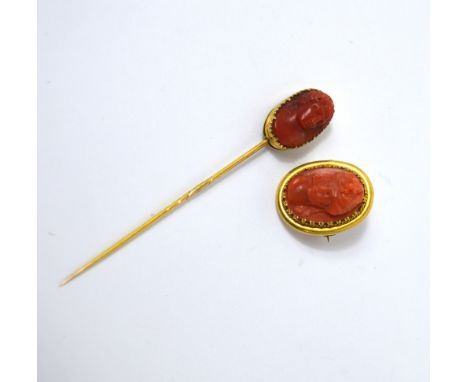 A 19th century yellow metal framed carved cameo brooch and a similar 19th century yellow metal framed carved cameo stick pin 