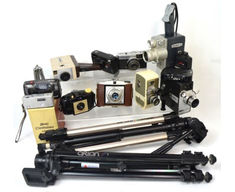 A Bell and Howell cine camera and other vintage cameras to include accessories and tripods.