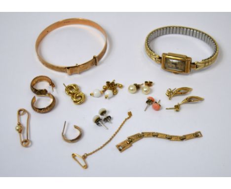 A 9ct rose gold bangle, a 9ct gold cased ladies' tank style wristwatch on plated base metal expandable strap and a further qu