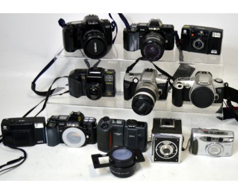 A boxed Nikkon Coolpix 995 digital camera, a boxed Minolta 7000SLR 35mm camera body, a selection of other SLR cameras and a c