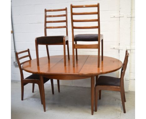 A retro G-Plan teak extending oval dining table on rounded tapering legs, width approx 170cm and a matching set of four ladde