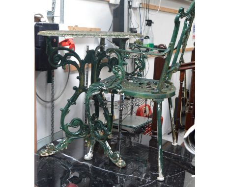 A green painted pierced metal garden table on tripod support, diameter 59cm and a set of four green painted metal chairs (5).