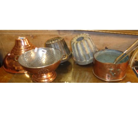 A copper colander, two Victorian tin aspic moulds, a skimmer, a ladle, etc.