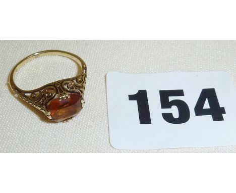 Ornate gold ring (marked as 14K) with amber coloured stone filigree setting, 1.8g approx size 'K'