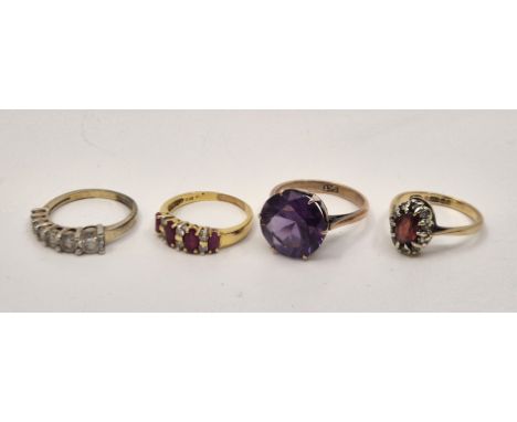 A yellow metal, ruby and diamond ring, set four graduated mixed marquise cut rubies alternating with pairs of round brilliant