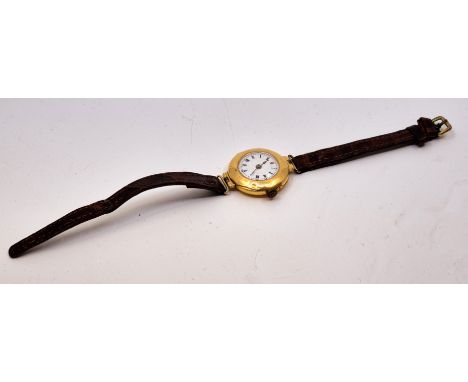 An 18ct. gold ladies' wrist watch, manual movement, having circular white enamel Roman numeral dial with outer minutes track,