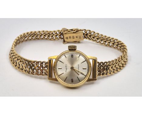 An 18ct. gold Magnific ladies' wrist watch,&nbsp;manual movement, having signed silvered circular dial with applied gold bato