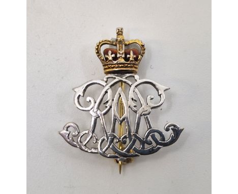 Military Interest: A yellow and white metal and red enamel military badge, (metal assessed as 18ct. gold and platinum), heigh