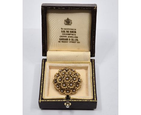 A 18ct. gold and diamond flower brooch,&nbsp;the domed circular brooch fashioned as a bunch of flowerheads, each flower rotat