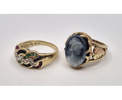 A 9ct. gold, ruby, sapphire, emerald and diamond Celtic knot design ring, channel set six each of graduated round cut rubies,