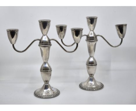 A pair of American sterling three section silver three branch candelabra,&nbsp;convertible into a pair of single candlesticks