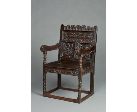 A RARE AND UNUSUAL LANCASHIRE OAK BOX SEATED ARMCHAIR, FROM EAST BARSHAM MANOR, NORFOLK, CIRCA 1660-1670. The armchair with f