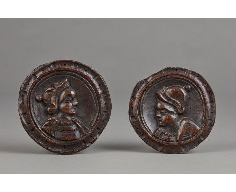 A SMALL PAIR OF TUDOR PORTRAIT ROUNDEL PANELS. ENGLISH, CIRCA 1530–1550. The small roundel plaques with a notch and punch pat
