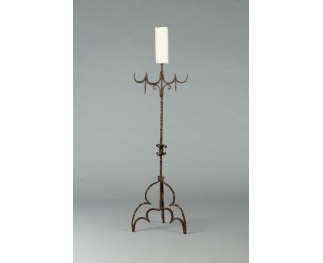 AN ELIZABETHAN WROUGHT IRON CANDELABRA, ENGLISH, CIRCA 1580-1600. Having a single pricket above four wrought C cusps with twi