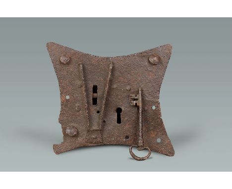 A MEDIEVAL WROUGHT IRON LOCK-PLATE, ENGLISH, CIRCA 1400-1450. The lockplate with curved sides retaining original hasp guards 