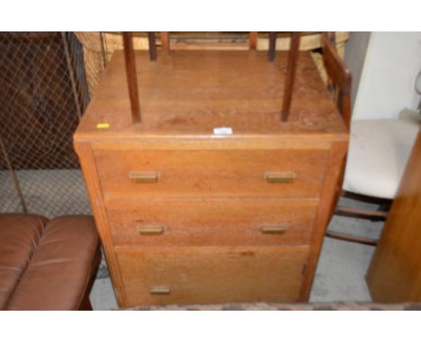 A light oak chest fitted three long drawers 