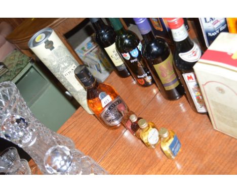 Four miniature bottles of various whisky; a bottle of Glayva Scotch Whisky and a bottle Oban Scotch Whisky