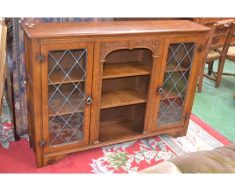 An oak bookcase with glazed leaded light
