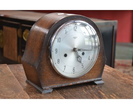 A Smiths oak cased chiming mantel clock, silvered dial, Arabic numerals, with key